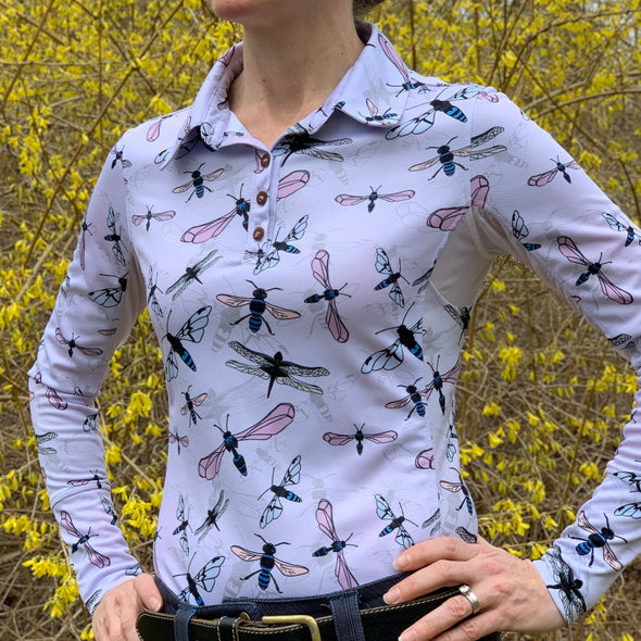 woman wearing long sleeve sun shirt polo with UPF or SPF protection and lavender flying insects design