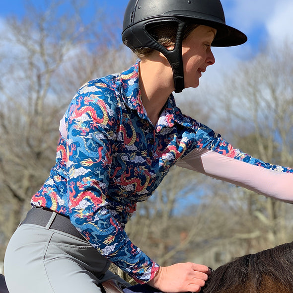 Horseback rider wearing long sleeve sun shirt polo with UPF or SPF protection and red and blue dragon design