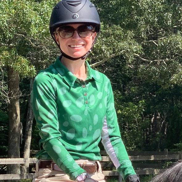 Horseback rider wearing long sleeve sun shirt polo with UPF or SPF protection and green appaloosa spots design